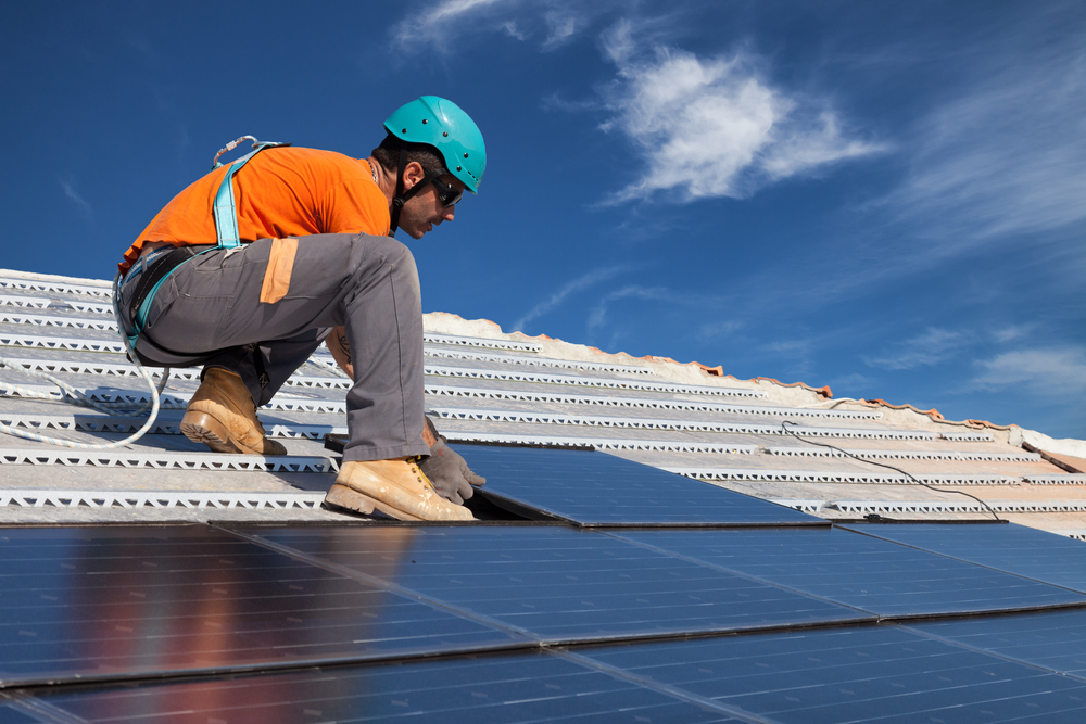 technician install new generation photovoltaic solar panels on roof